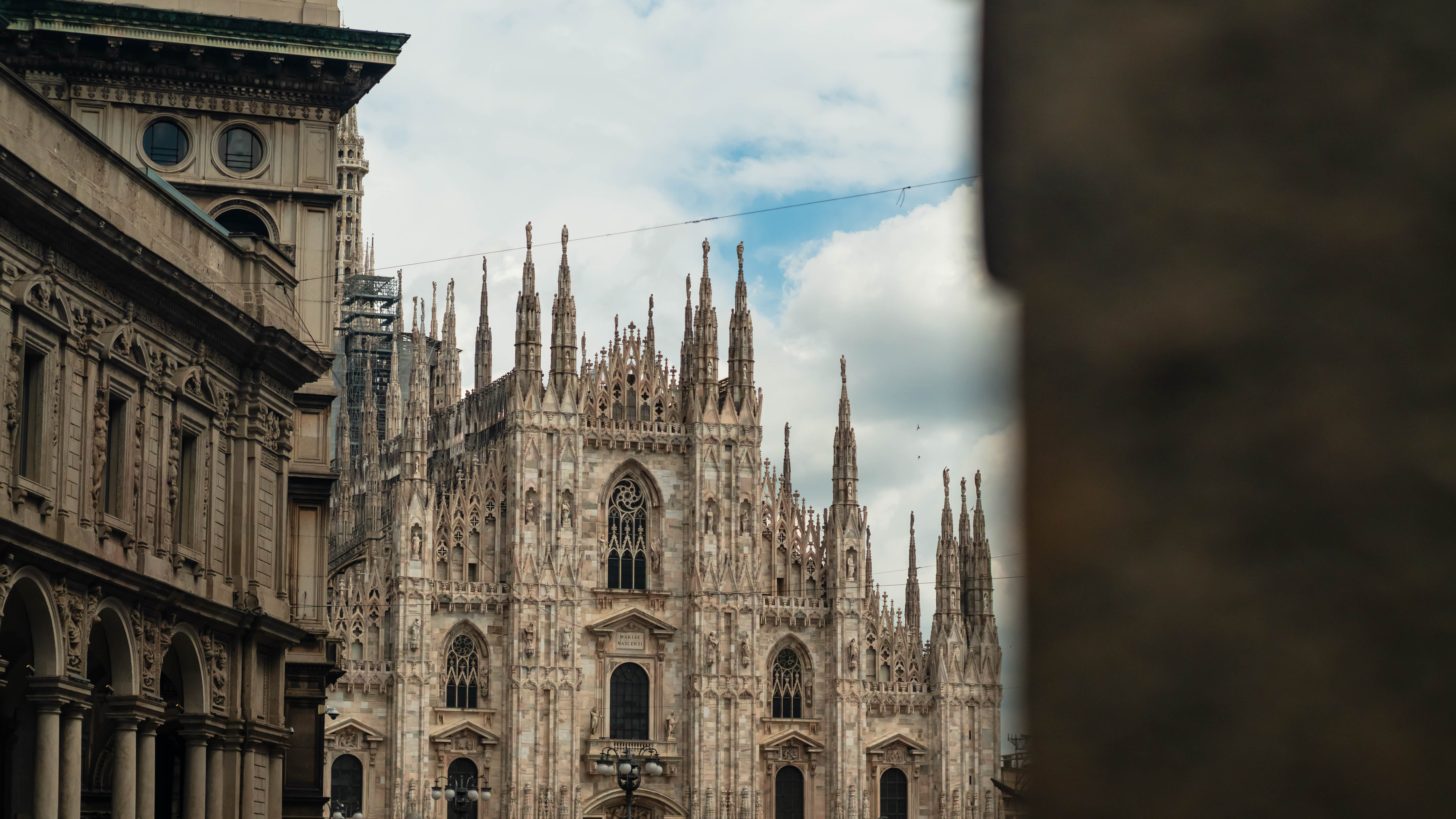 Beautiful view of the Milan Cathedral (Duomo) from behind a column