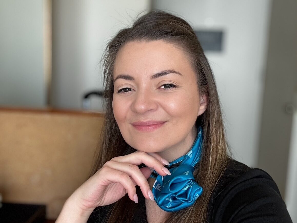 Portrait of flight attendant with natural light and relaxed setting



