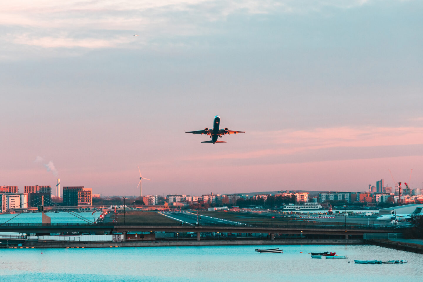 commercial airliner departing from the runway at sunset
